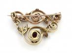 Garland style ruby and diamond brooch in yellow gold