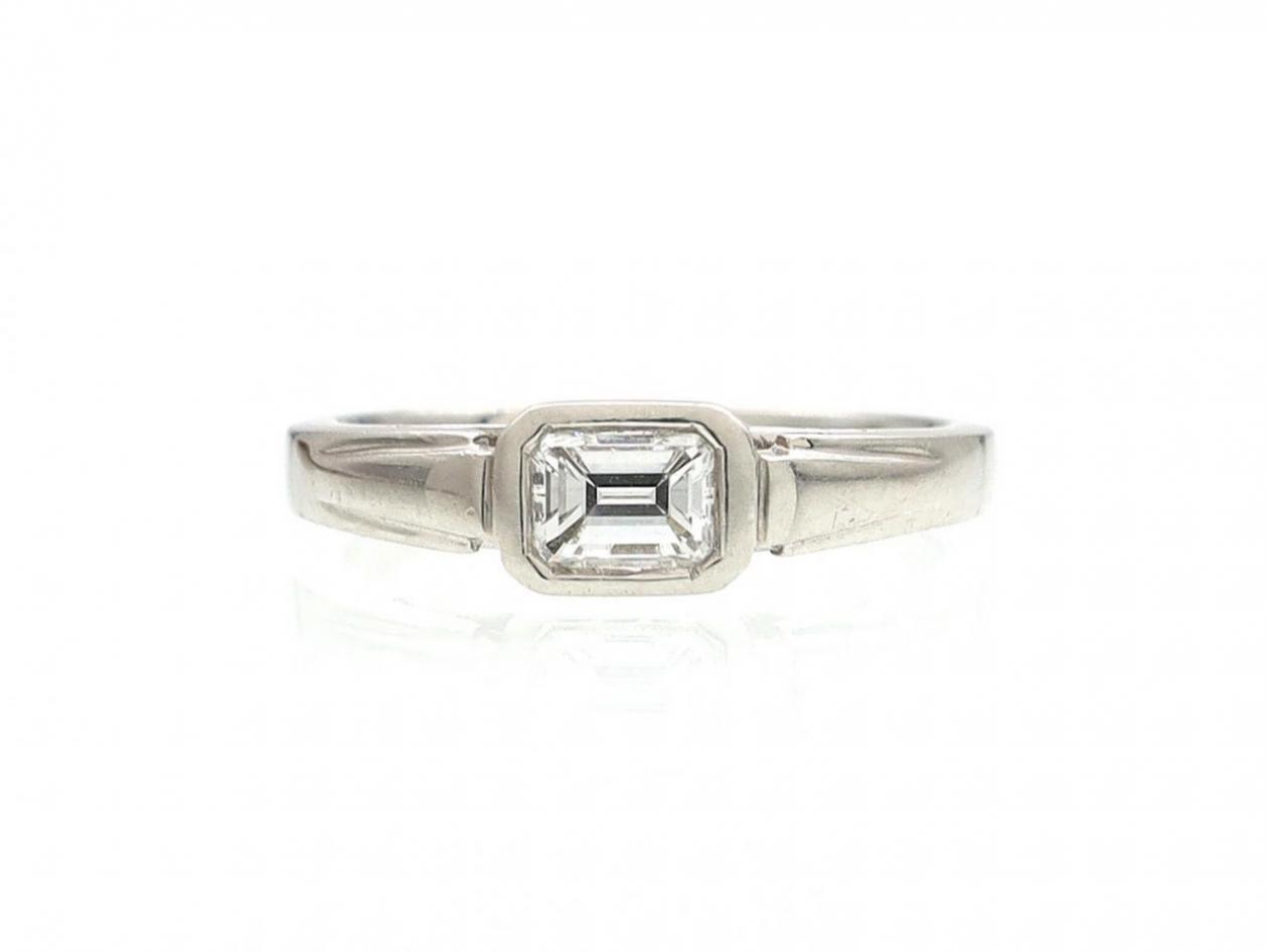 Art Deco style emerald cut diamond east to west diamond solitaire ring