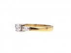 Flanked diamond solitaire engagement ring in 18kt yellow gold