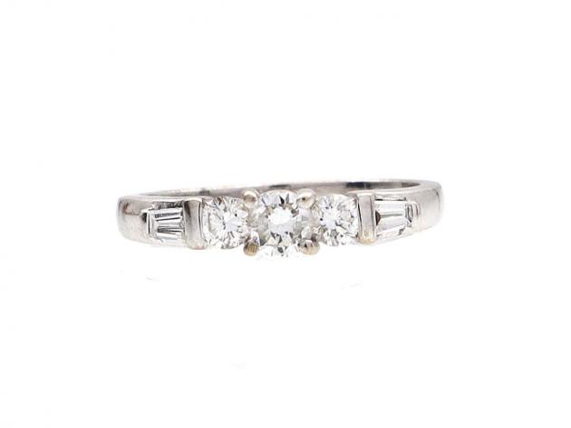 Diamond flanked solitaire engagement ring in 18kt white gold