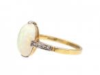 Edwardian oval opal solitaire ring with diamond shoulders