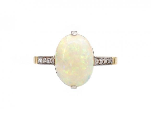 Edwardian oval opal solitaire ring with diamond shoulders