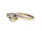 Contemporary emerald and yellow diamond two stone twist ring