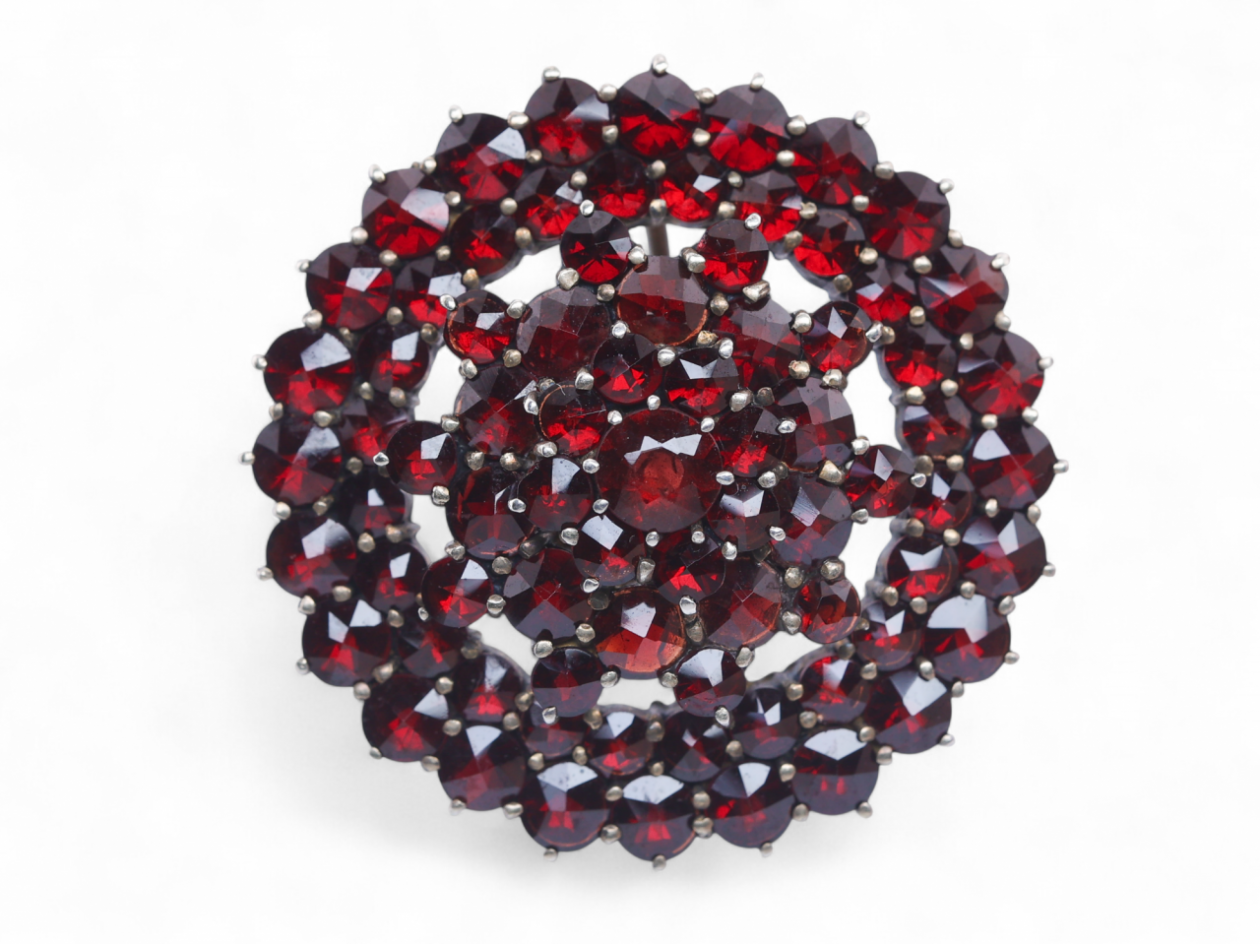 Antique silver gilt brooch set with rose-cut garnets in a domed circular cluster