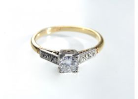 Art Deco diamond flanked solitaire in platinum and gold