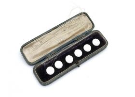 Antique set of round white enamel buttons