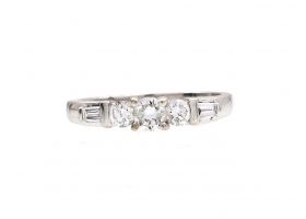 Diamond flanked solitaire engagement ring in 18kt white gold