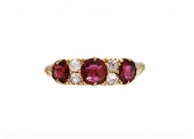 1889 ruby and diamond three stone carved ring in 18kt yellow gold