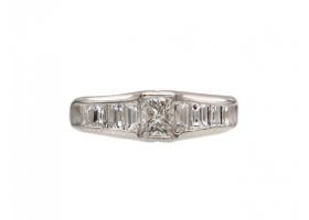Rectangular diamond flanked solitaire engagement ring in platinum