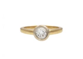 Bezel set diamond solitaire engagement ring in yellow gold