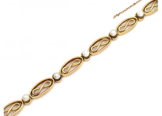French 18kt yellow gold infinity bracelet set with pearls