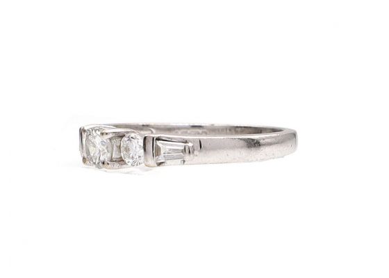 Diamond flanked solitaire engagement ring in 18kt white gold
