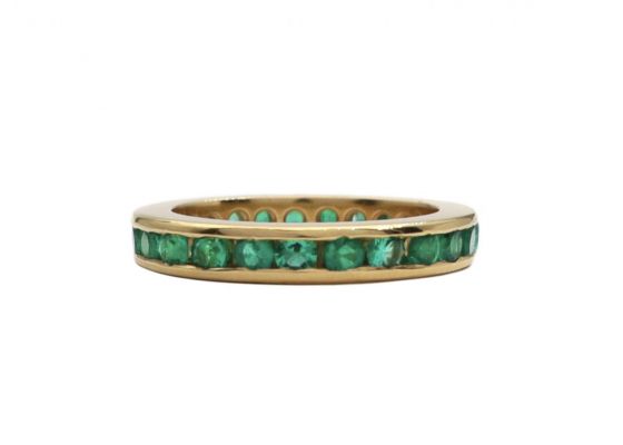 round cut emerald channel set full eternity ring 18kt yellow gold