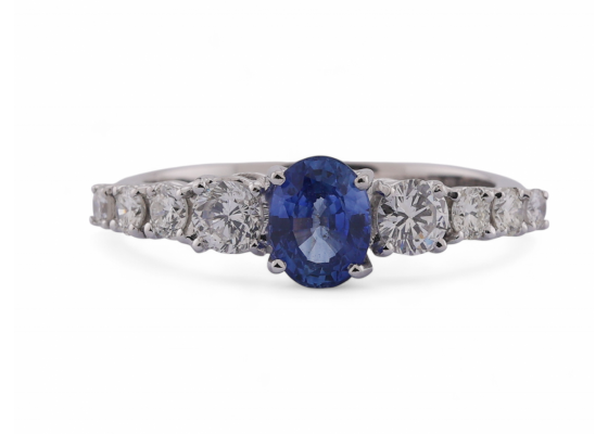 Modern Italian 18kt white gold ring with 0.90ct oval sapphire and 0.64ct diamond shoulders