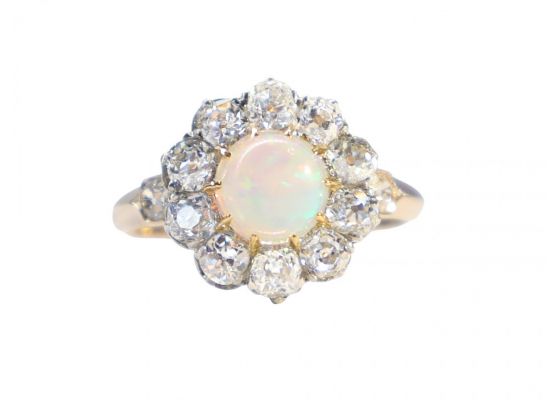 A Victorian cluster ring featuring a cabochon opal